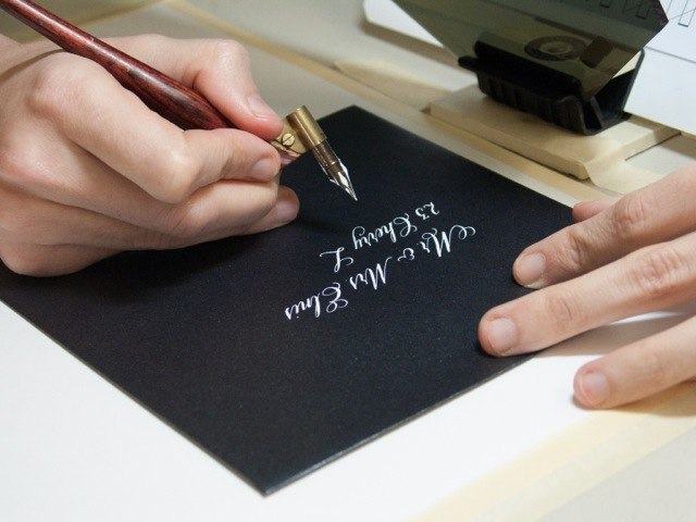 Detail of CSO member Rebecca Bruyere demonstrating envelope lettering at Popup Studio